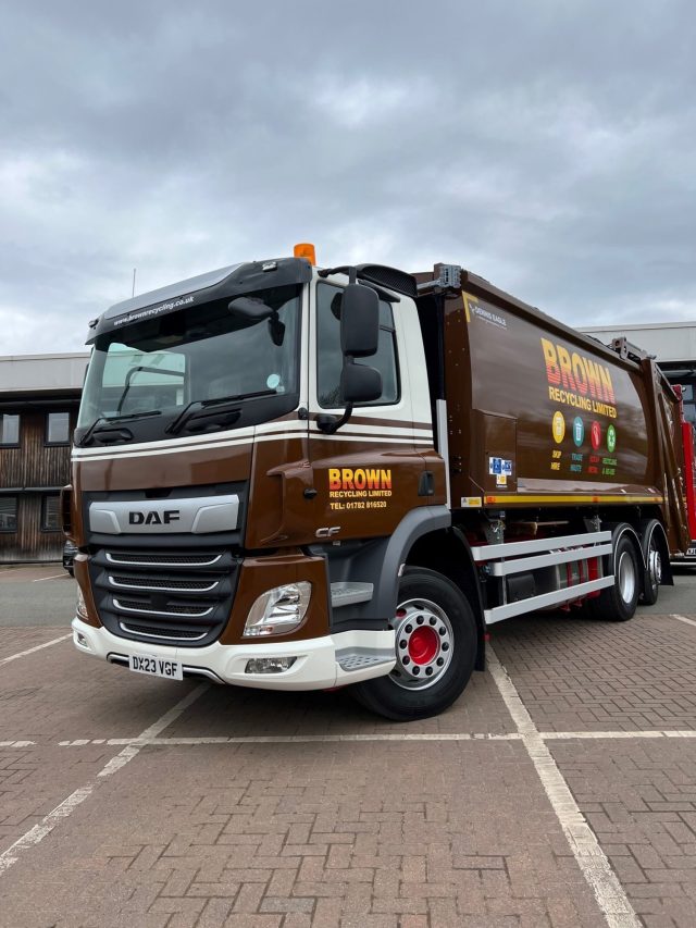 Brown recycling bin collection truck