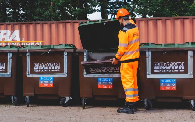 simpler recycling a year in review - a worker opens a brown recycling brown bin