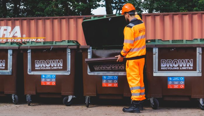 simpler recycling a year in review - a worker opens a brown recycling brown bin