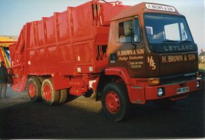 A 1982 LEYLAND refuse truck in the H BROWN & SON livery fitted with mechanical lifting equipment following the invention of kerbside plastic wheelie bins.